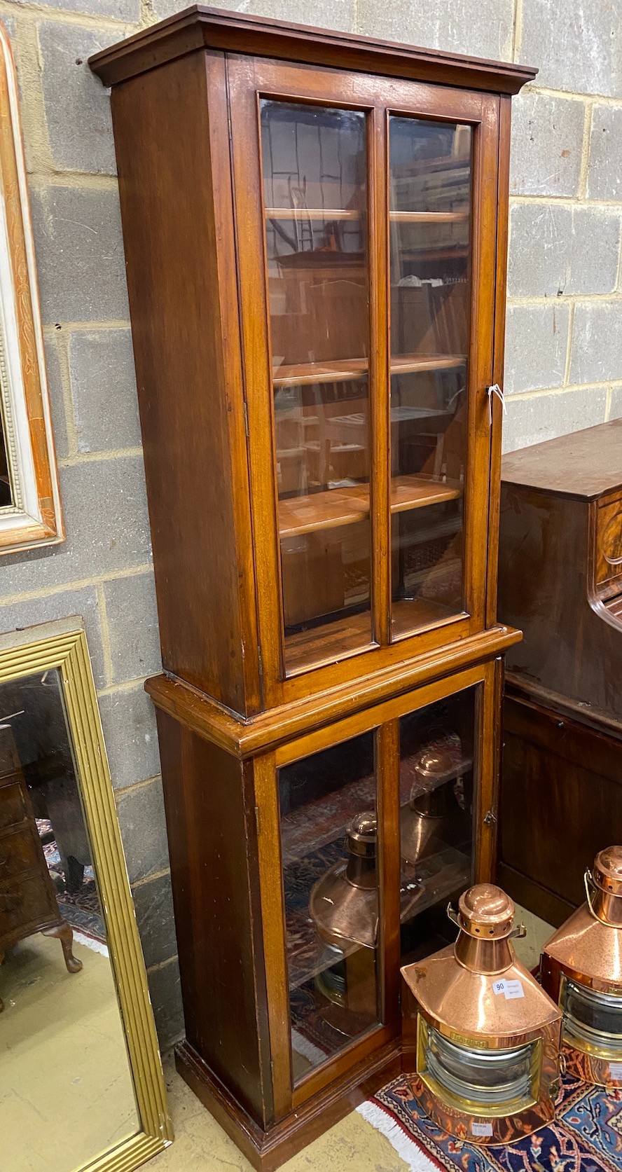 A late Victorian mahogany bookcase of narrow proportions, width 73cm, depth 34cm, height 201cm